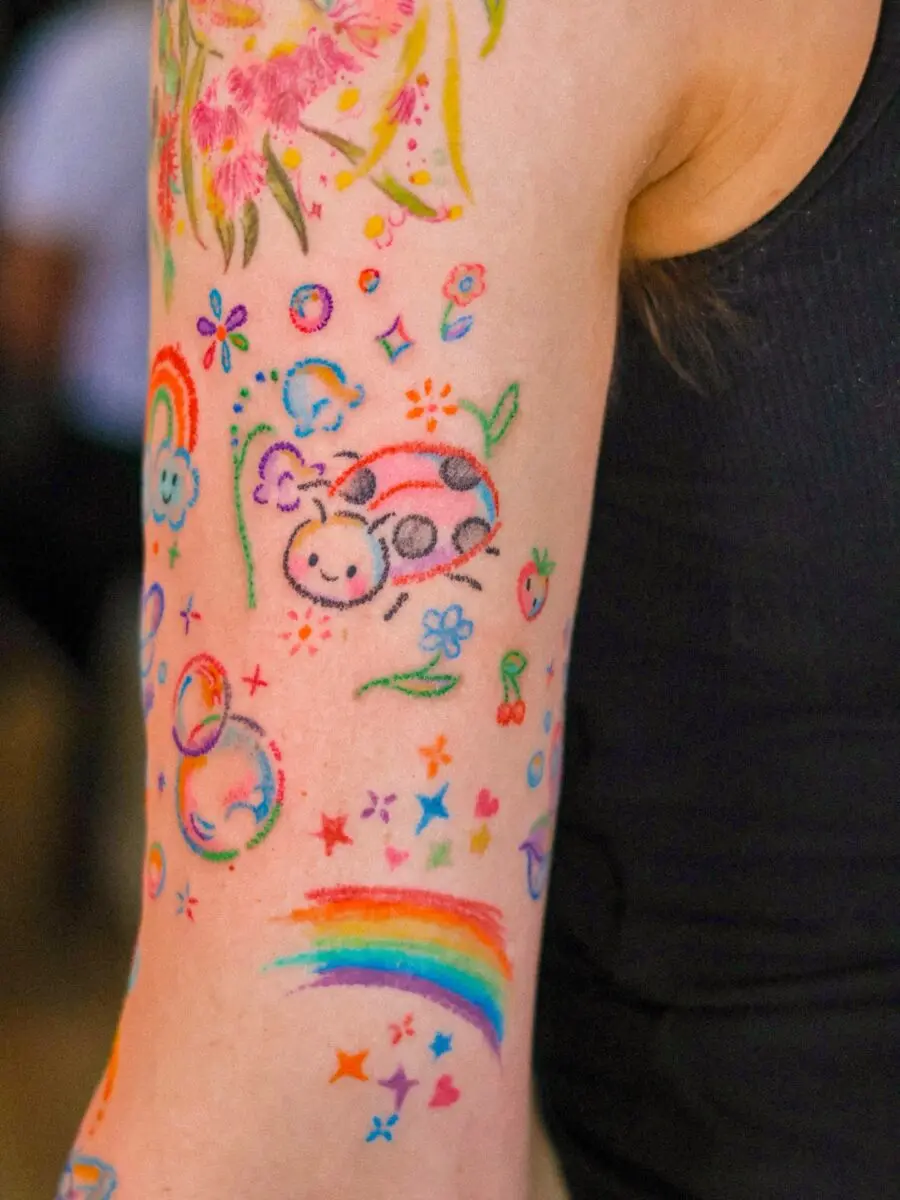Playful and colorful rainbow baby tattoos showcased here