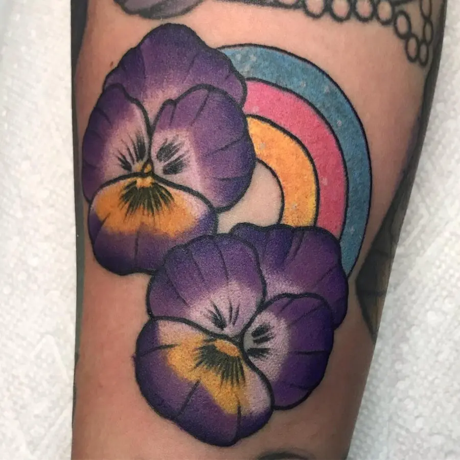 Vibrant rainbow baby tattoo with pansies