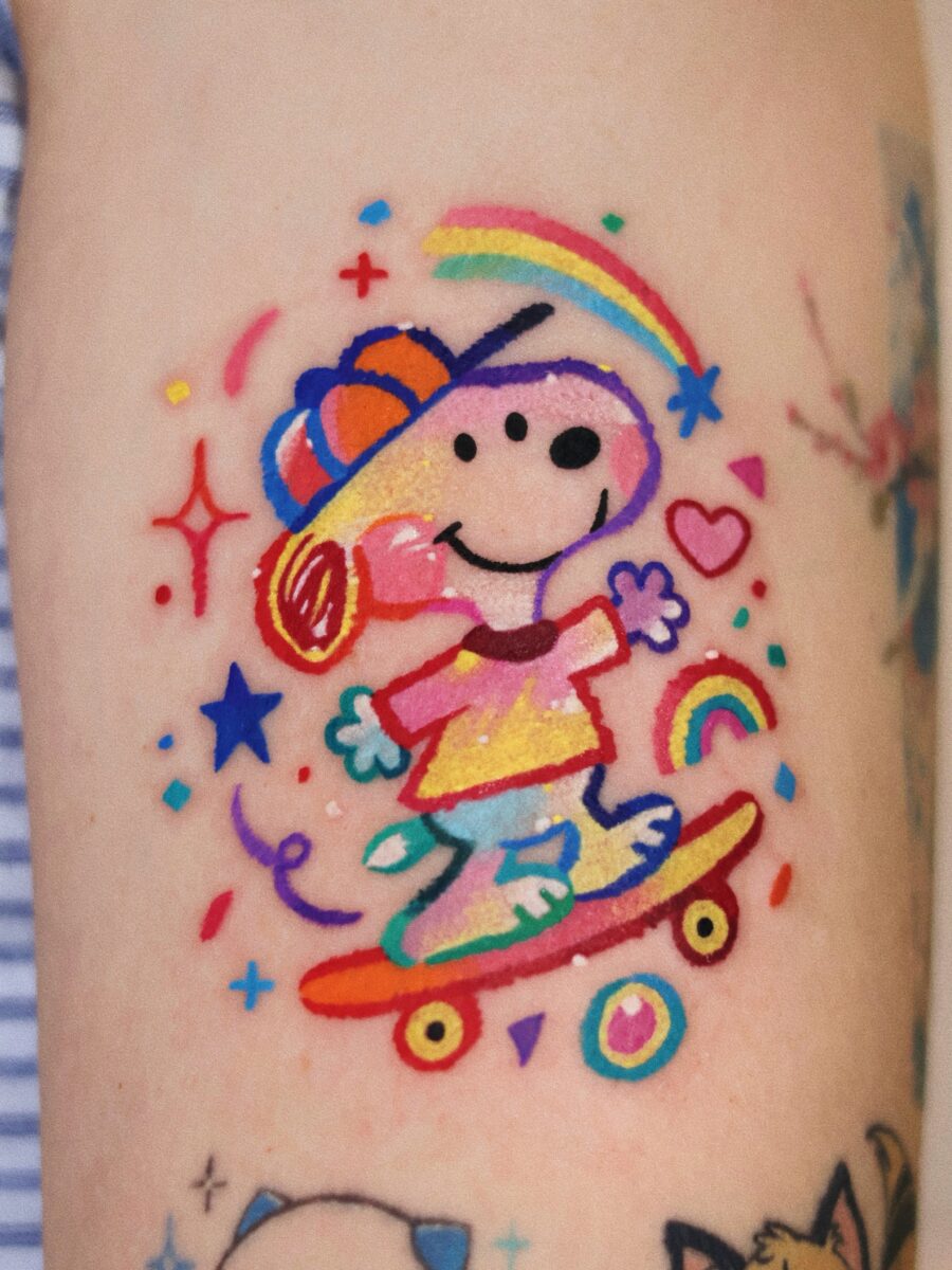 Bright and playful Snoopy skateboard tattoo