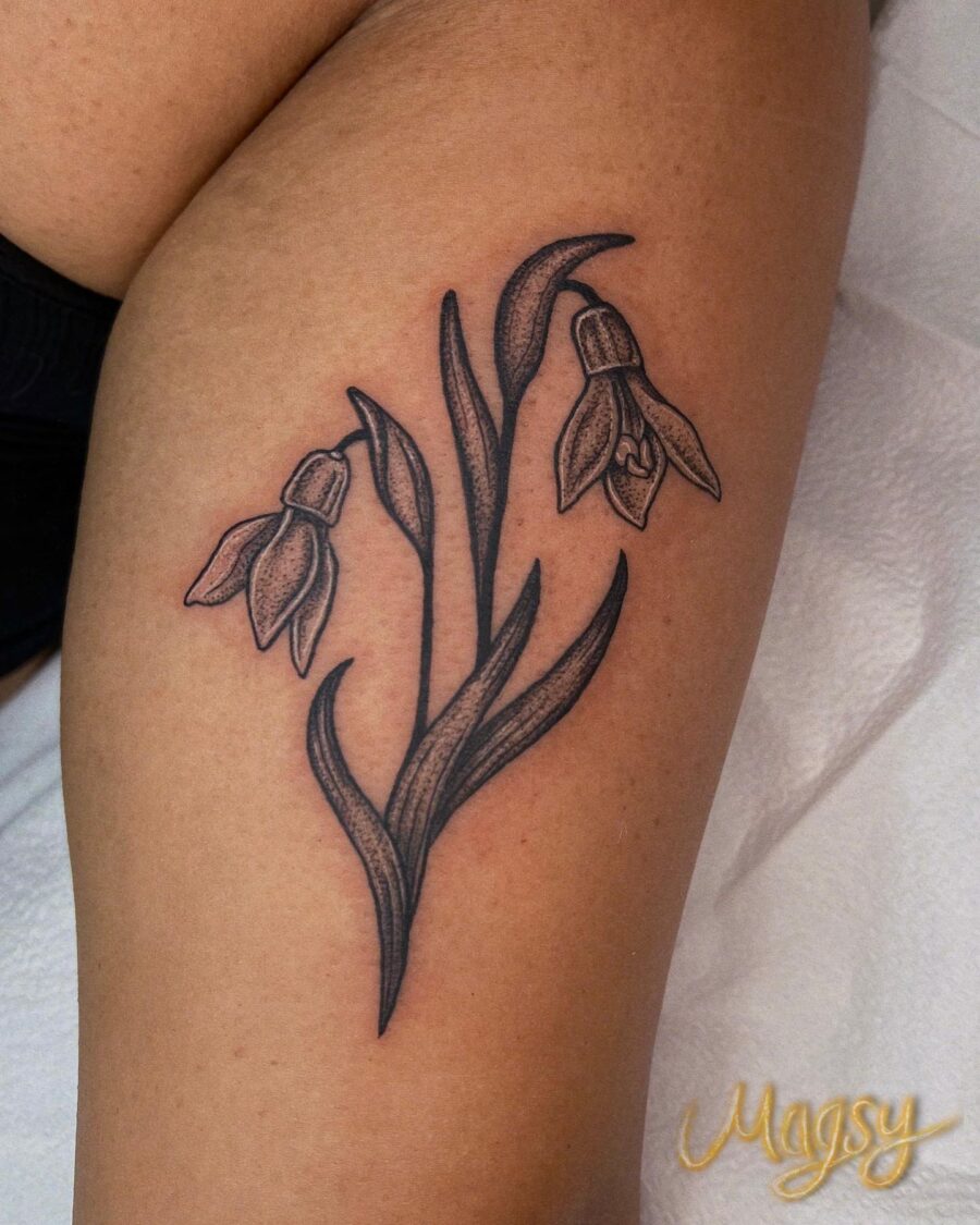 Elegant black and gray snowdrop flower tattoo.