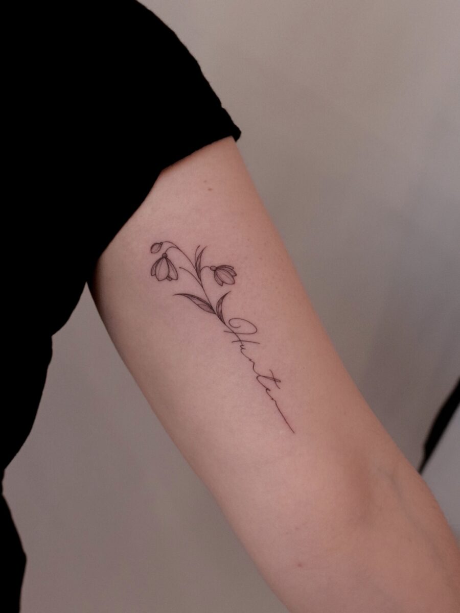 Elegant snowdrop tattoo embracing natural beauty