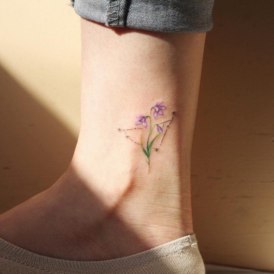 Elegant snowdrop tattoo with starry accents