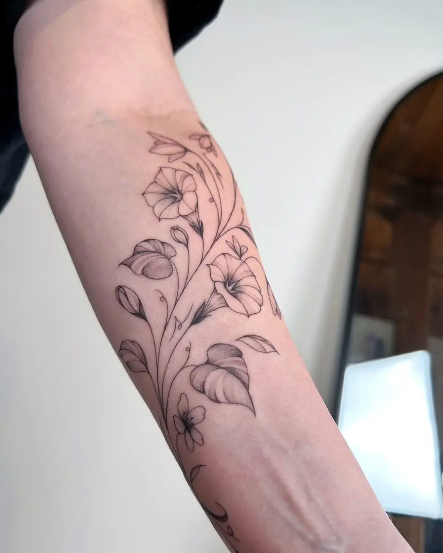 Elegant snowdrop tattoo design on forearm