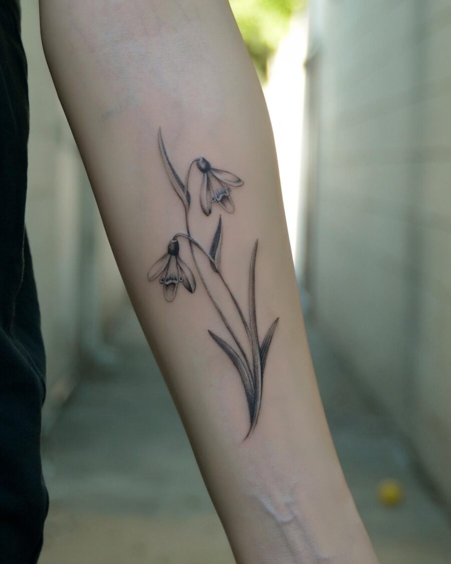 Elegant snowdrop tattoo inked in fine detail