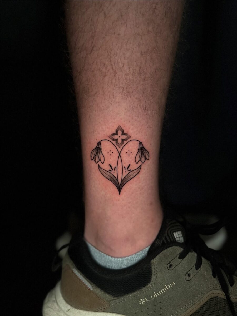 Elegant snowdrop tattoo on a leg