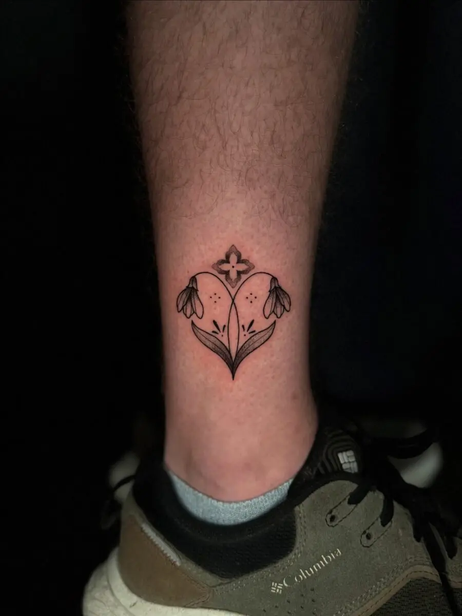 Elegant snowdrop tattoo on a leg