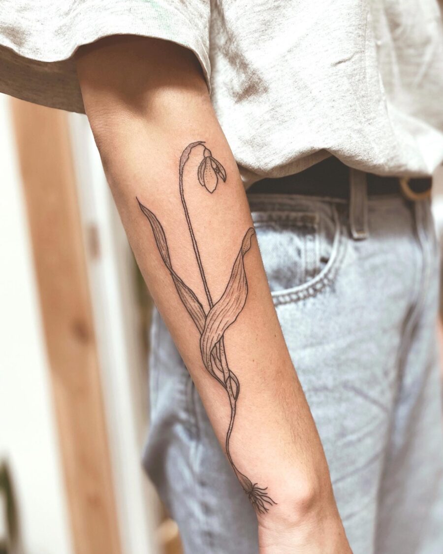 Elegant snowdrop tattoo on forearm