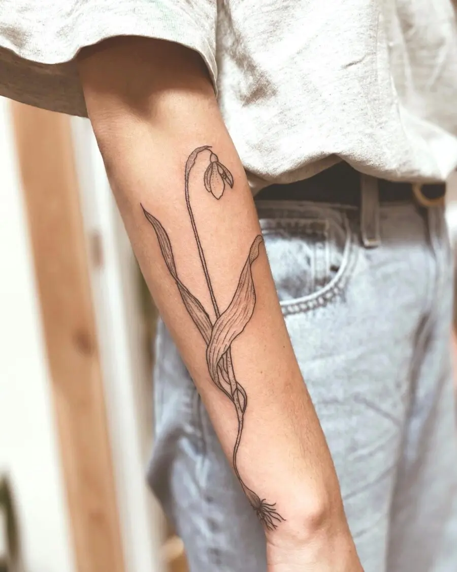 Elegant snowdrop tattoo on forearm