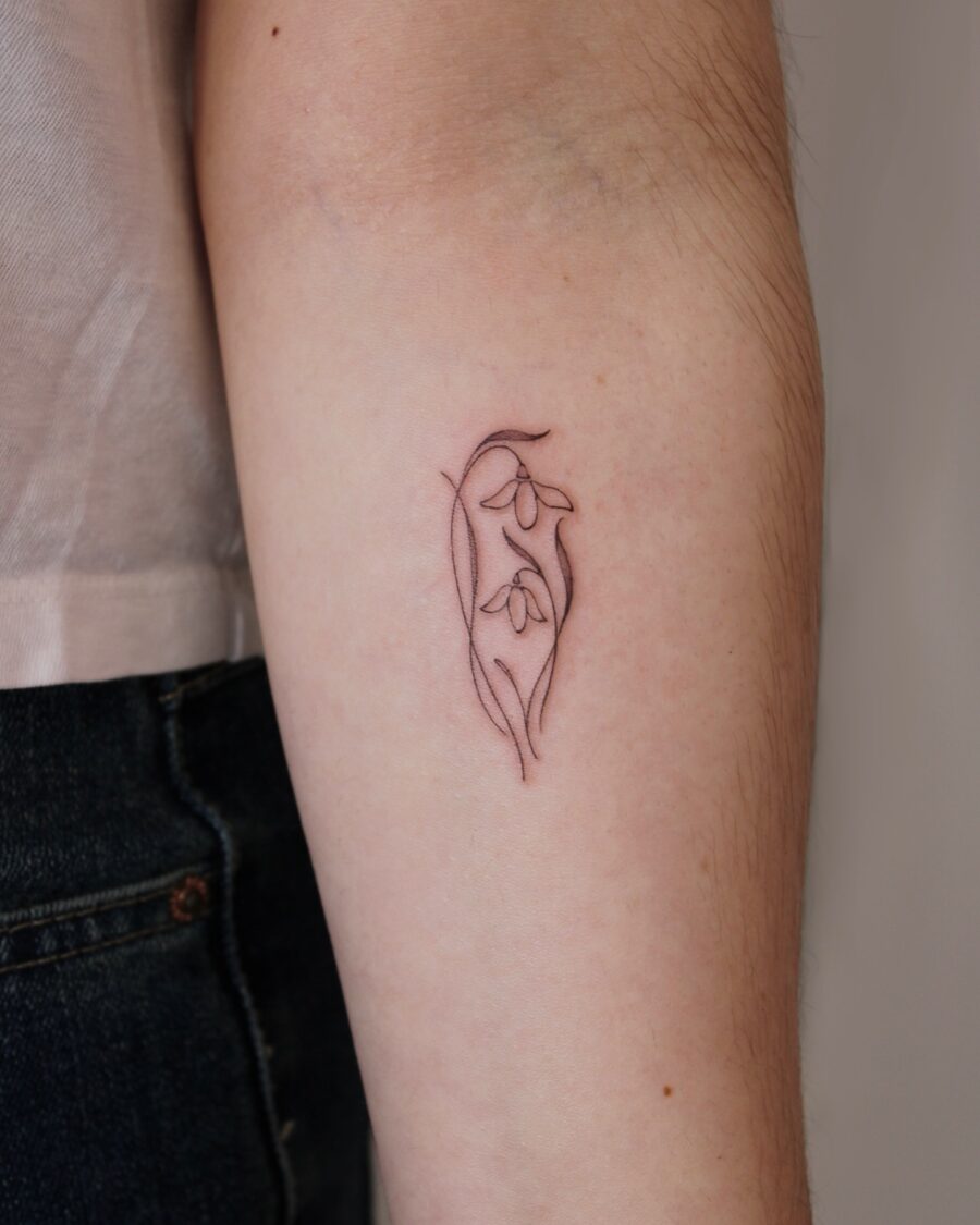 Elegant snowdrop tattoo showcasing delicate beauty