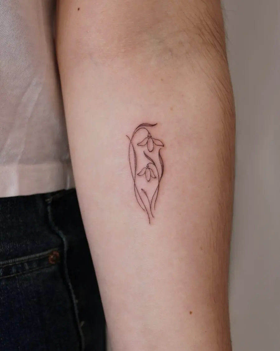 Elegant snowdrop tattoo showcasing delicate beauty