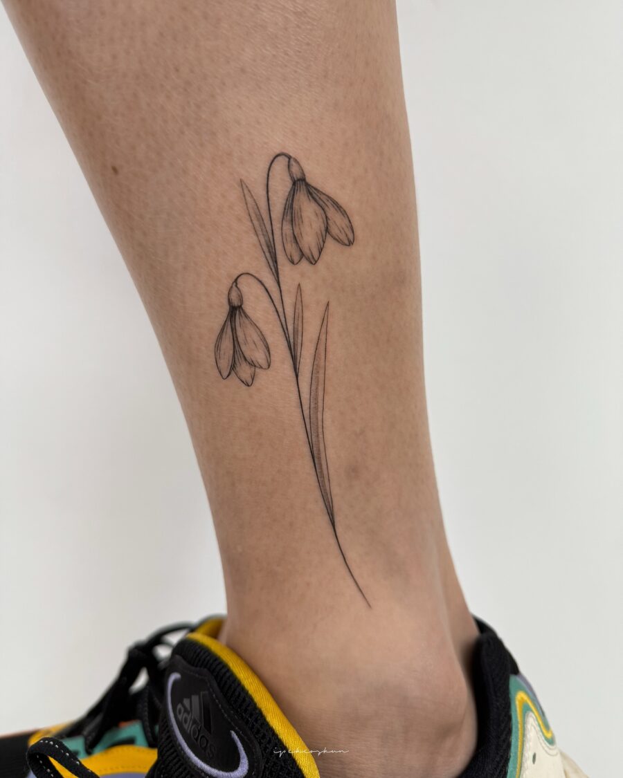 Elegant snowdrop tattoo adorned on the leg