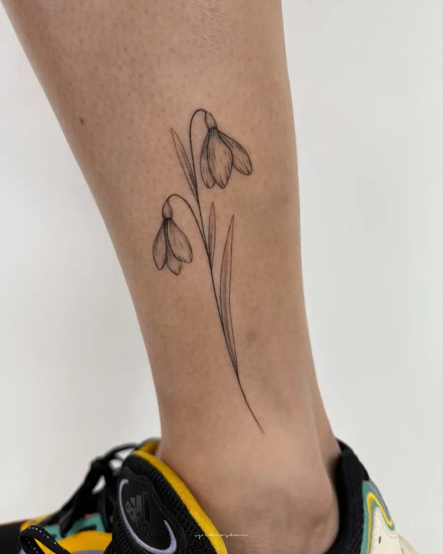 Elegant snowdrop tattoo adorned on the leg