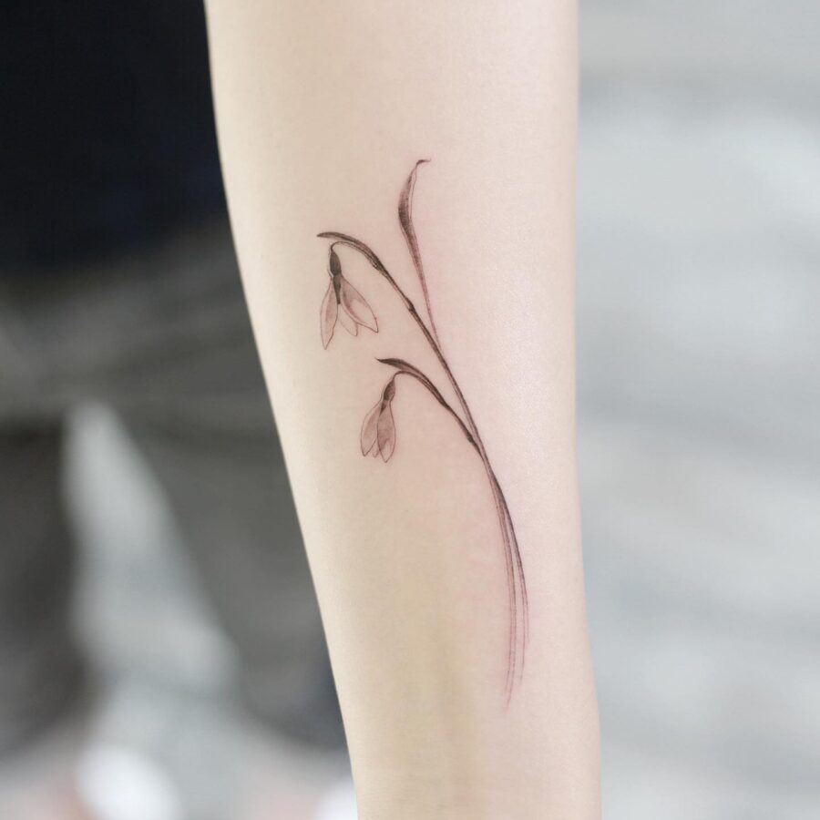 Elegant minimalist snowdrop flower tattoo design
