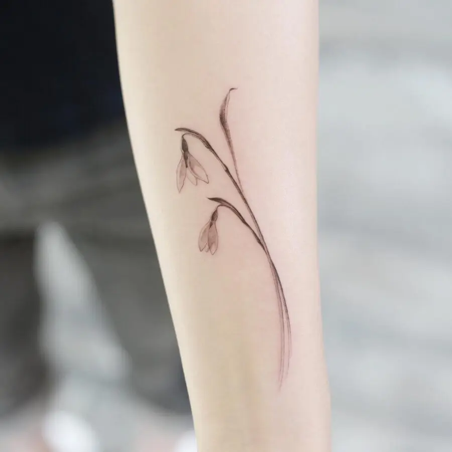 Elegant minimalist snowdrop flower tattoo design