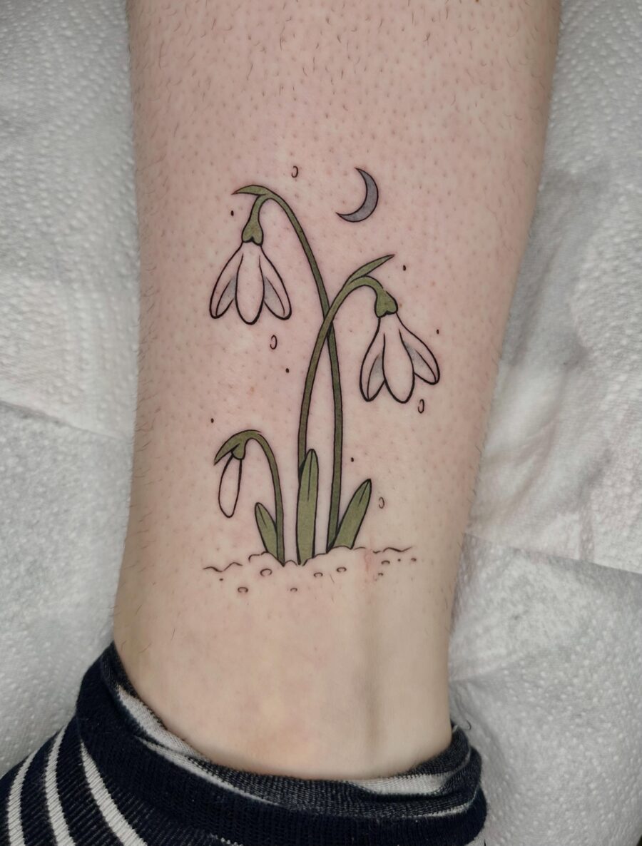 Charming snowdrop tattoo with crescent moon
