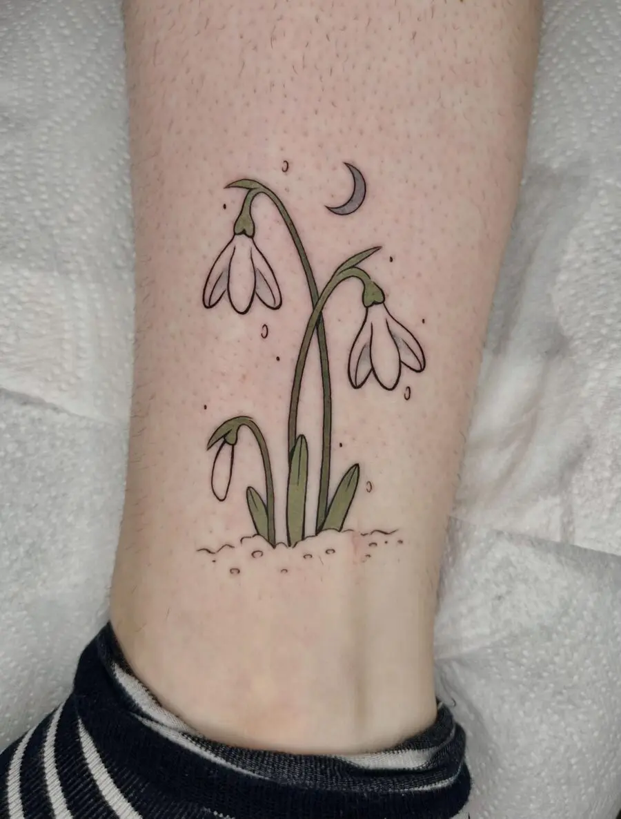 Charming snowdrop tattoo with crescent moon