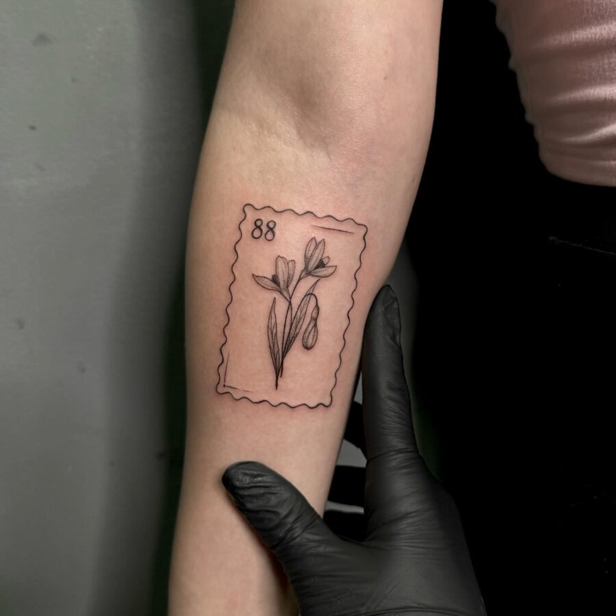 Elegant snowdrop tattoo in stamp design