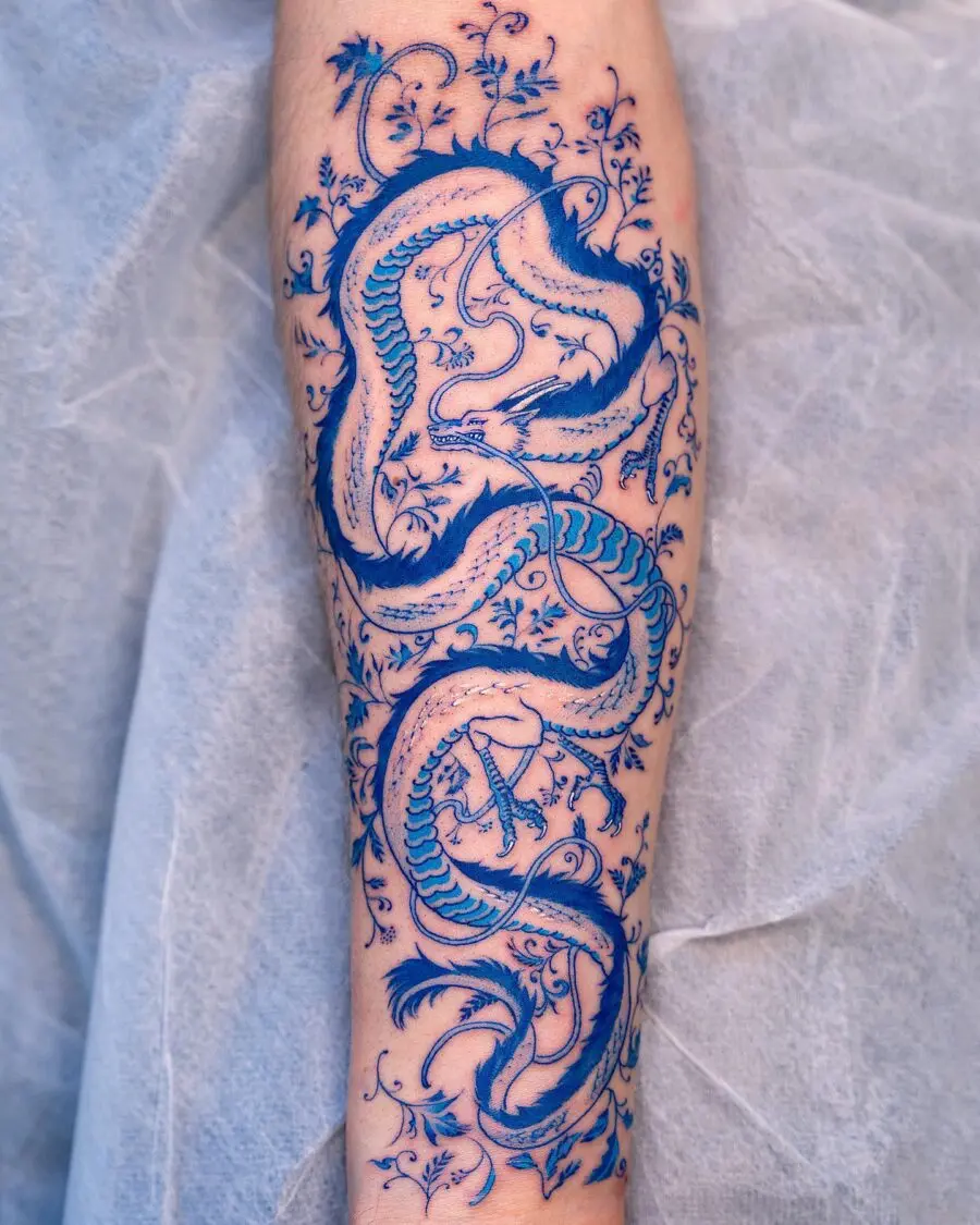 Intricate blue dragon tattoo with floral details