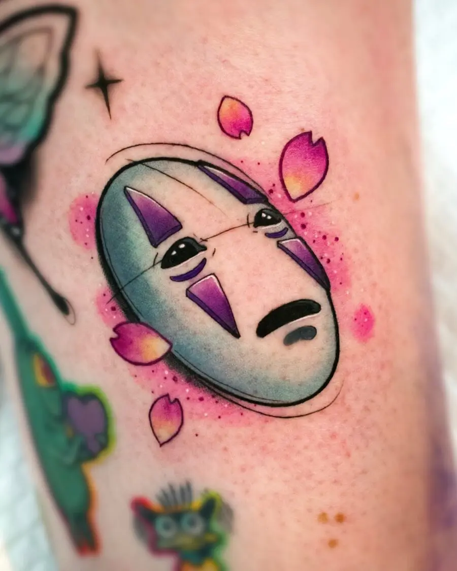 Whimsical No-Face Tattoo with Floral Accents