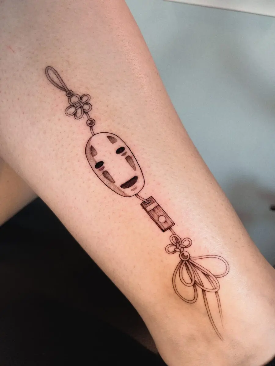 Elegant No-Face Tattoo with Floral Accents
