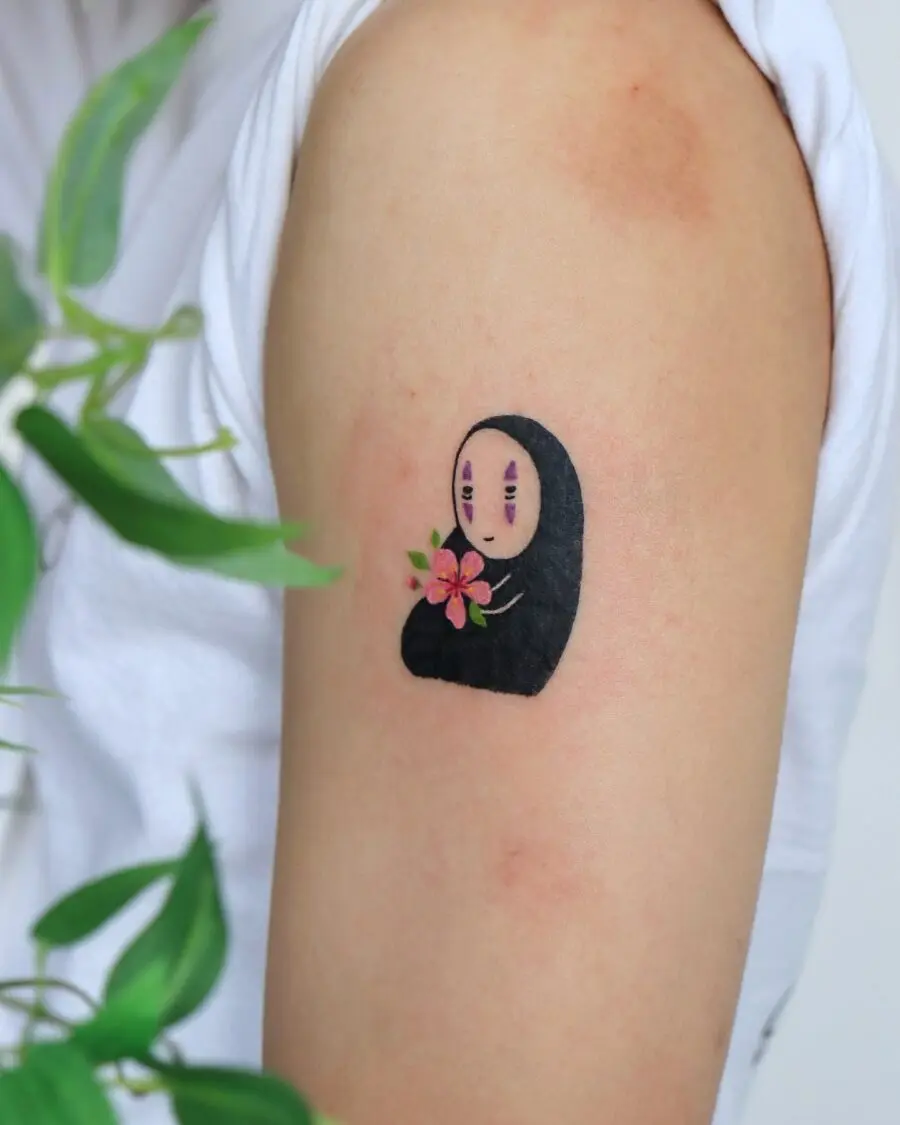 Charming No-Face Tattoo with Floral Detail