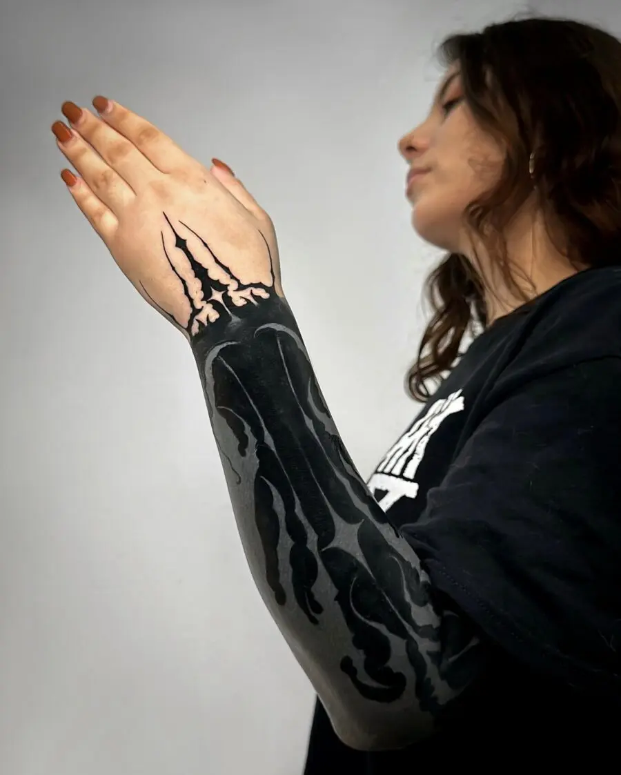 Intricate black sleeve tattoo showcasing bold artistry