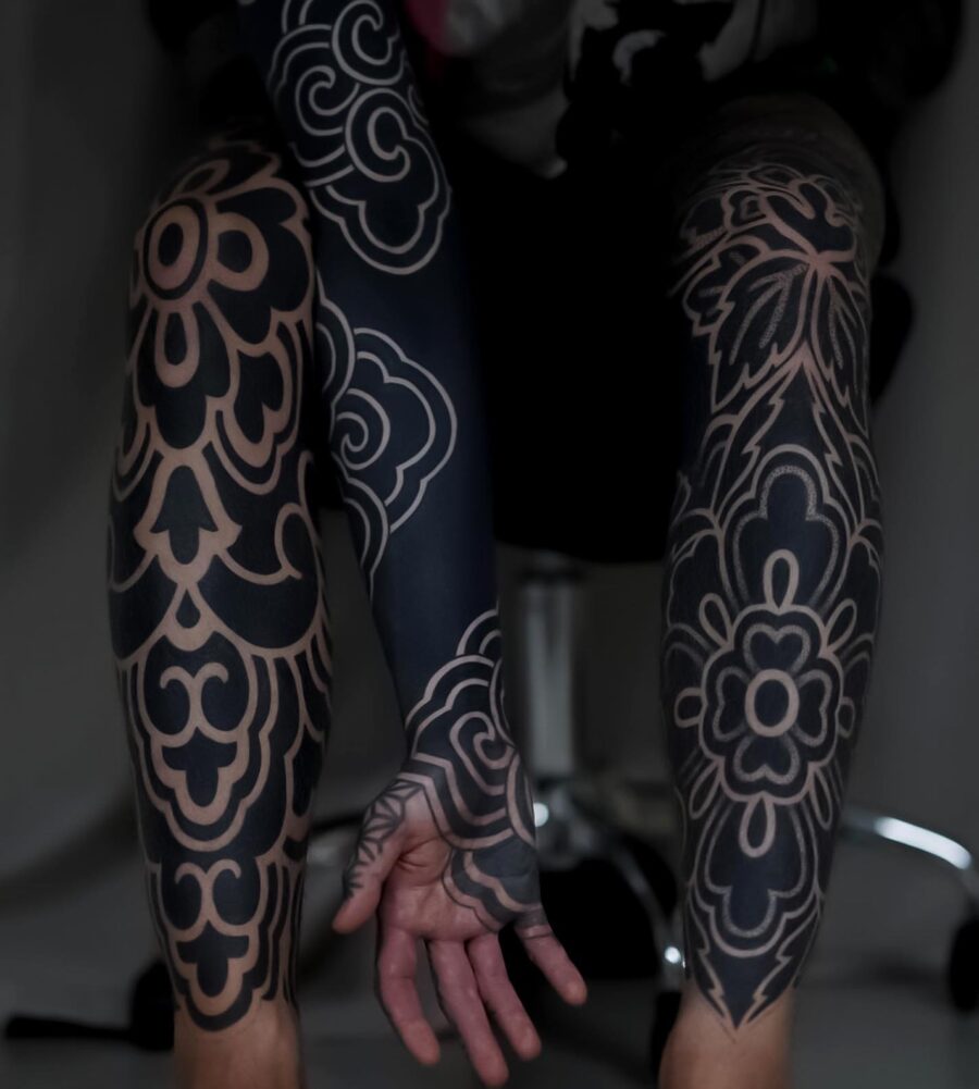 Intricate floral patterns on sleek black sleeves