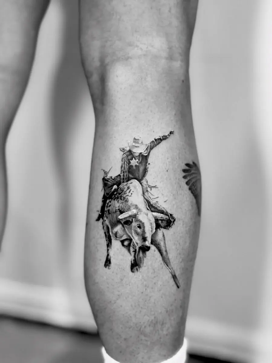 Dynamic cowboy bull riding tattoo design