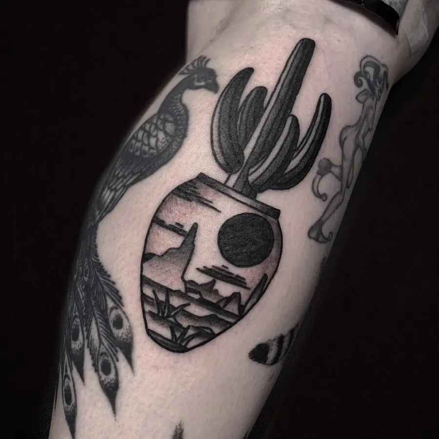 Unique cactus and mountain scene tattoo design