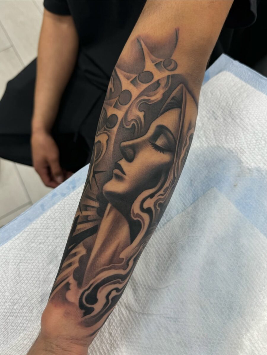 Elegant half sleeve tattoo with female visage