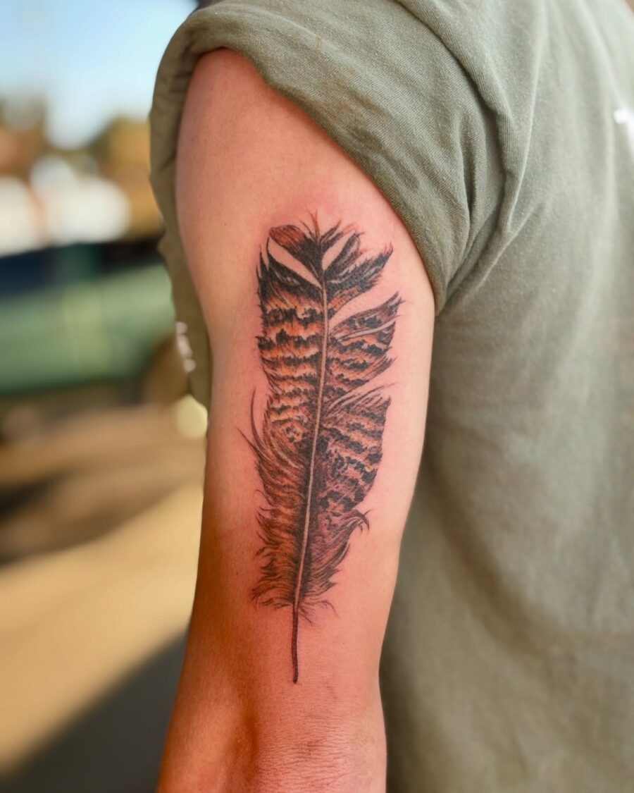 Elegant turkey feather tattoo on the arm