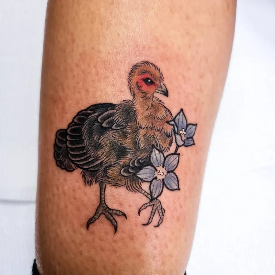 Vibrant turkey tattoo with floral accents