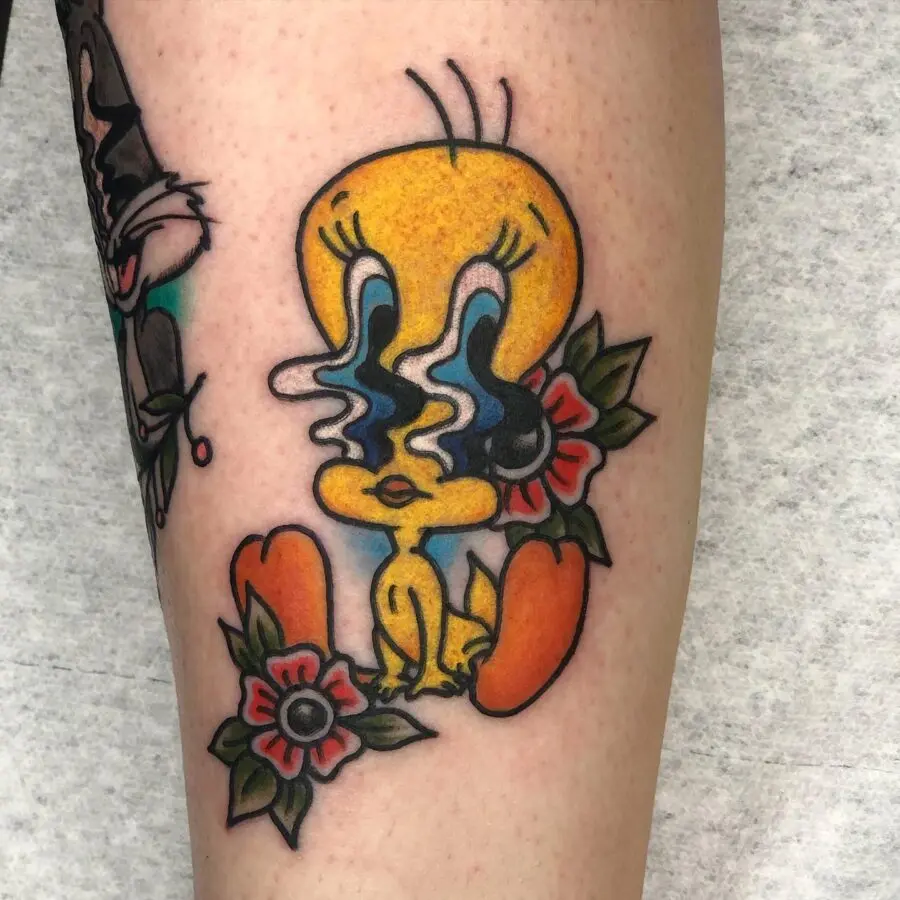 Vibrant Tweety Tattoo Surrounded by Flowers