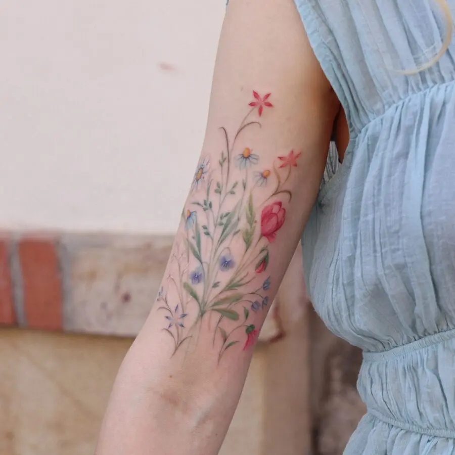 Colorful floral birth flower tattoo on arm