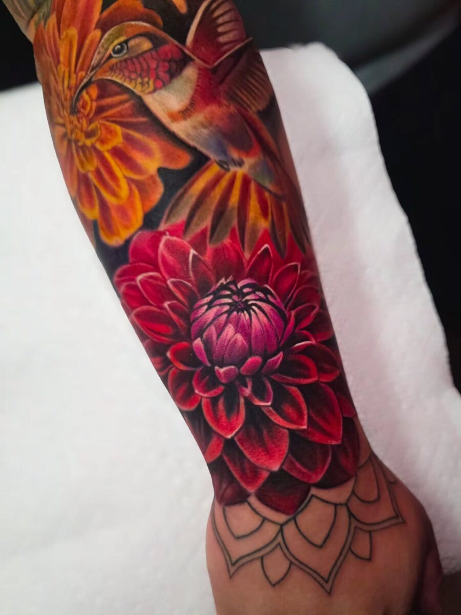 Colorful dahlia and hummingbird tattoo design.