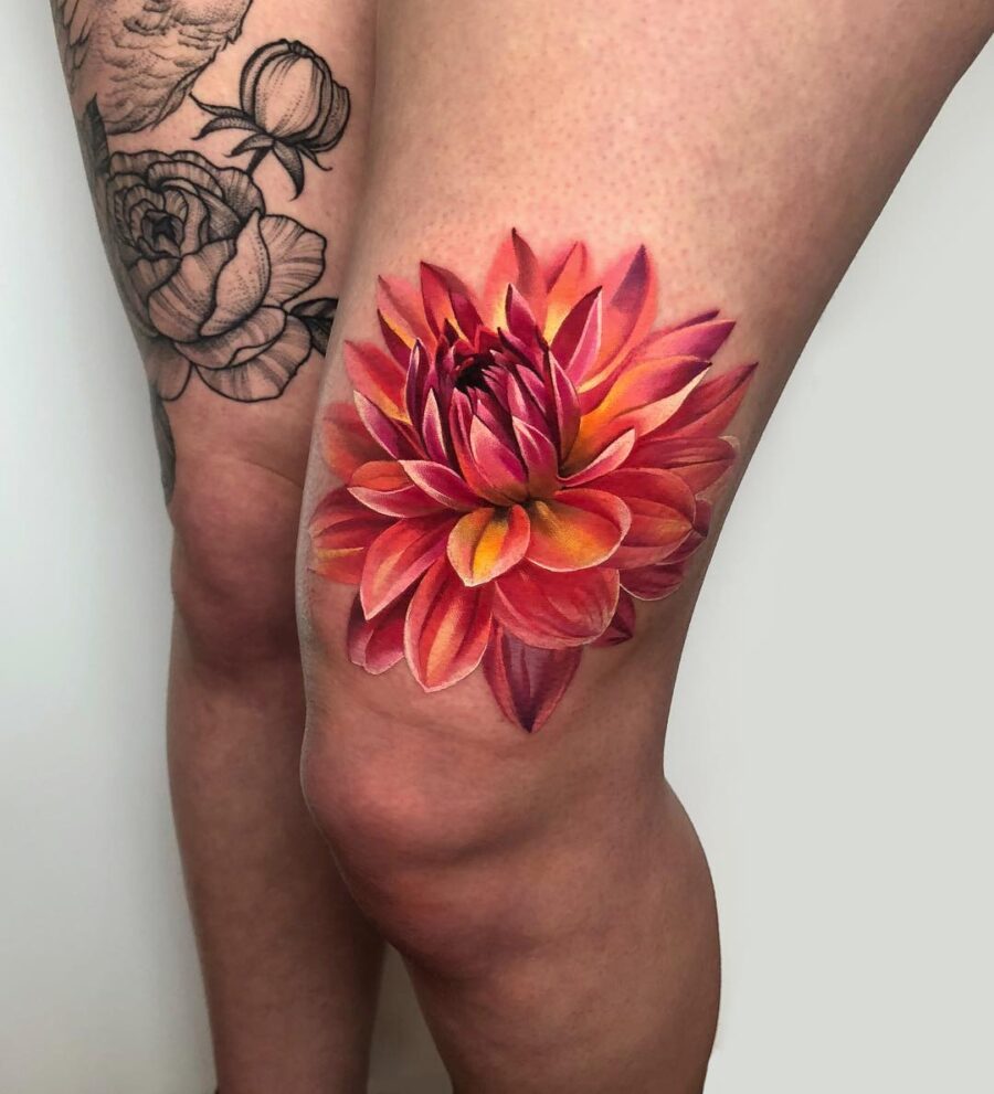 Stunning vibrant dahlia tattoo on thigh