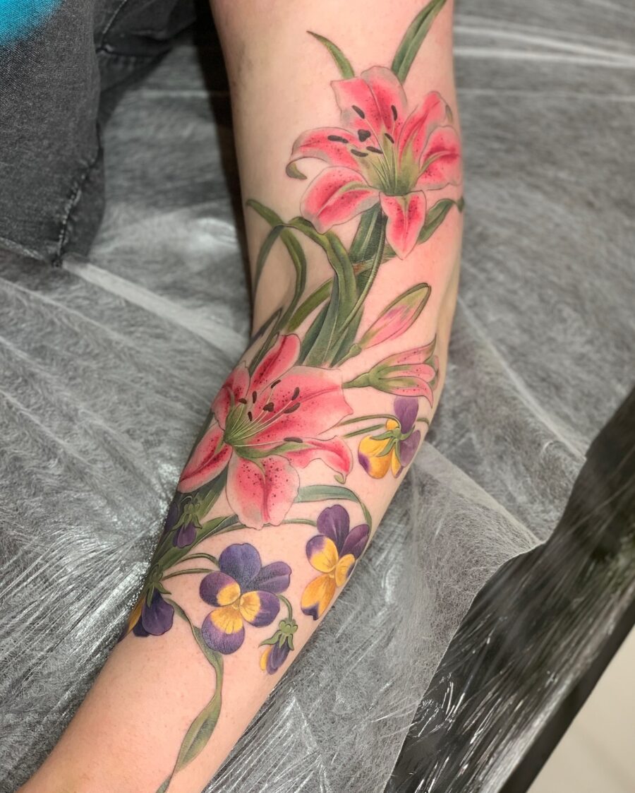 Stunning petunia and lily tattoo in vibrant colors