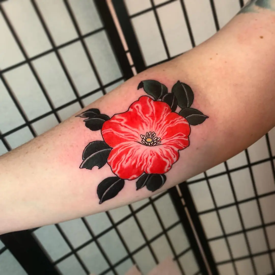 Vibrant red petunia tattoo with bold outlines