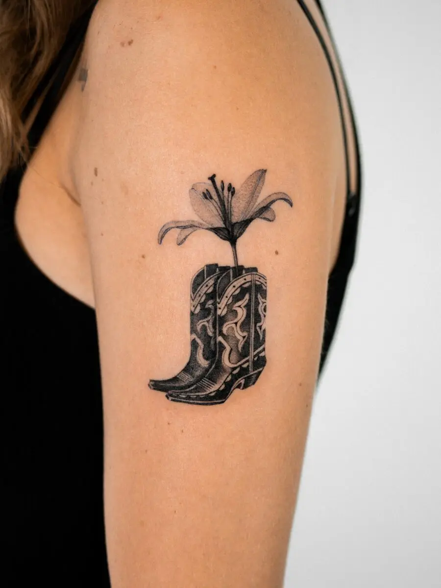 Stylish western boot tattoo with floral accents
