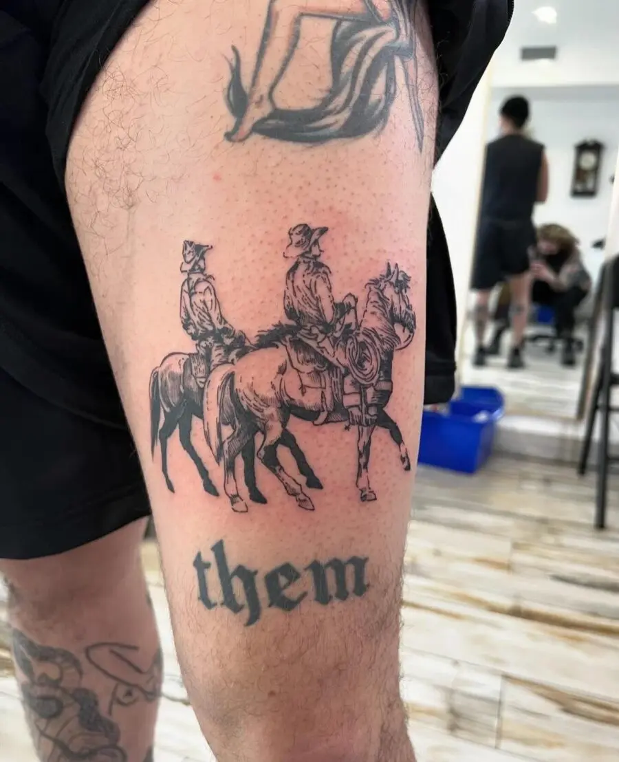 Detailed western-themed tattoo featuring riders