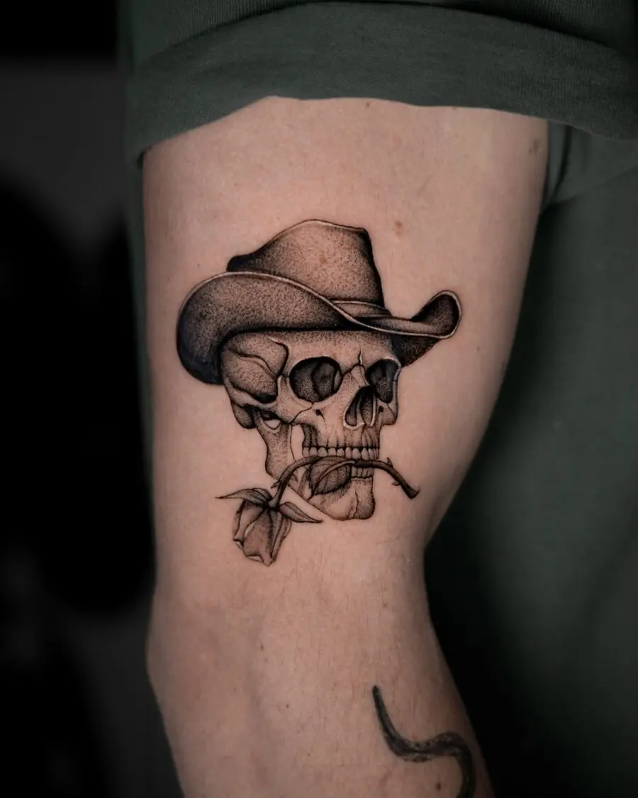 Intricate cowboy skull tattoo with floral elements