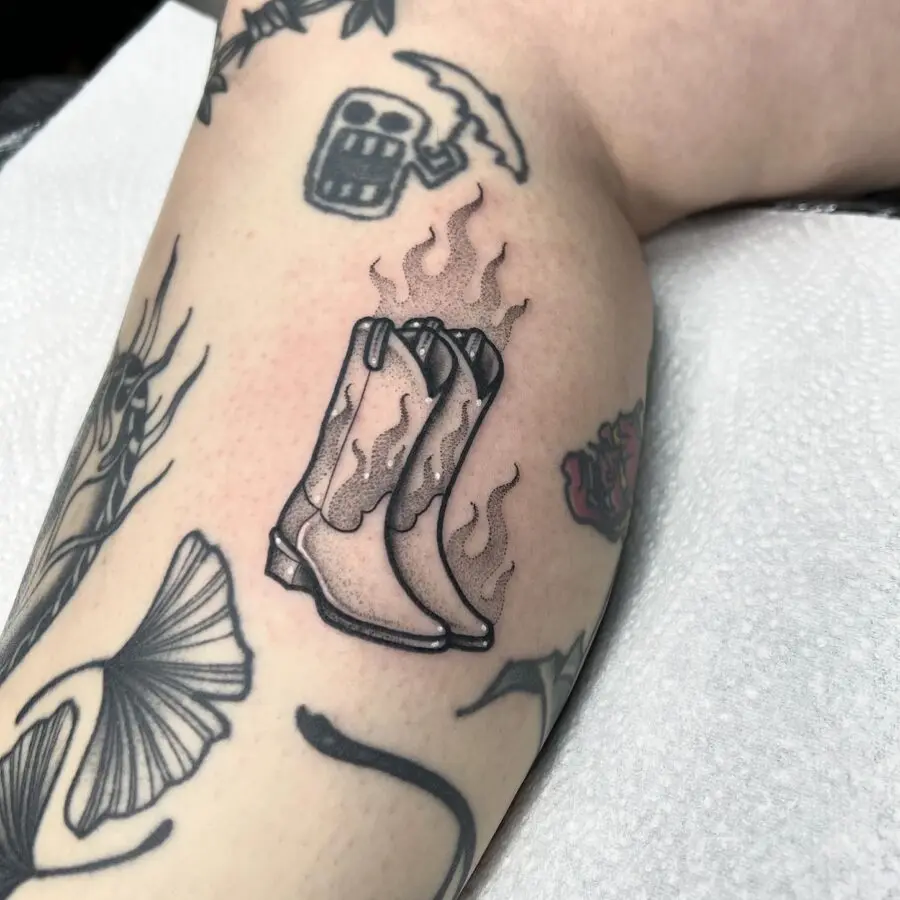 Flaming Cowboy Boots Tattoo Symbolizing Adventure