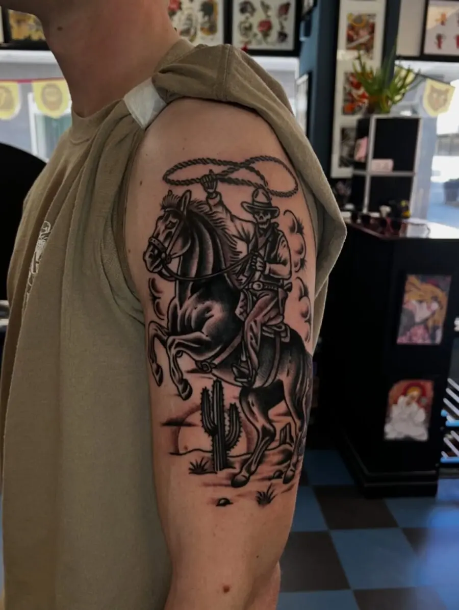 Intricate cowboy tattoo on muscular arm