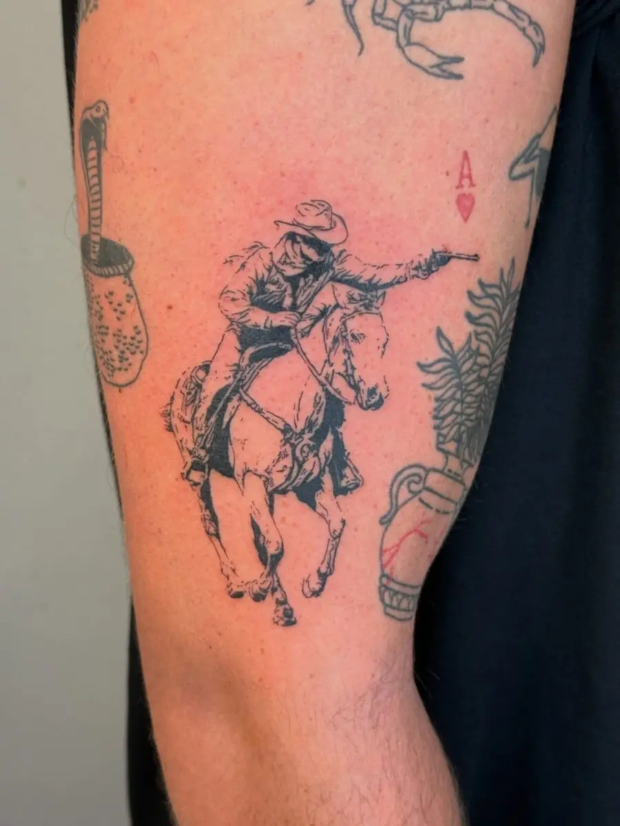 Classic cowboy riding a horse tattoo design