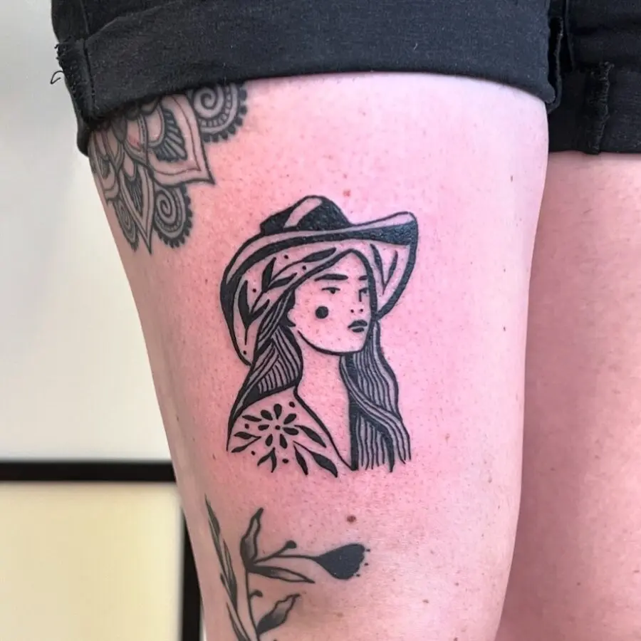 Stylish cowgirl tattoo with floral elements