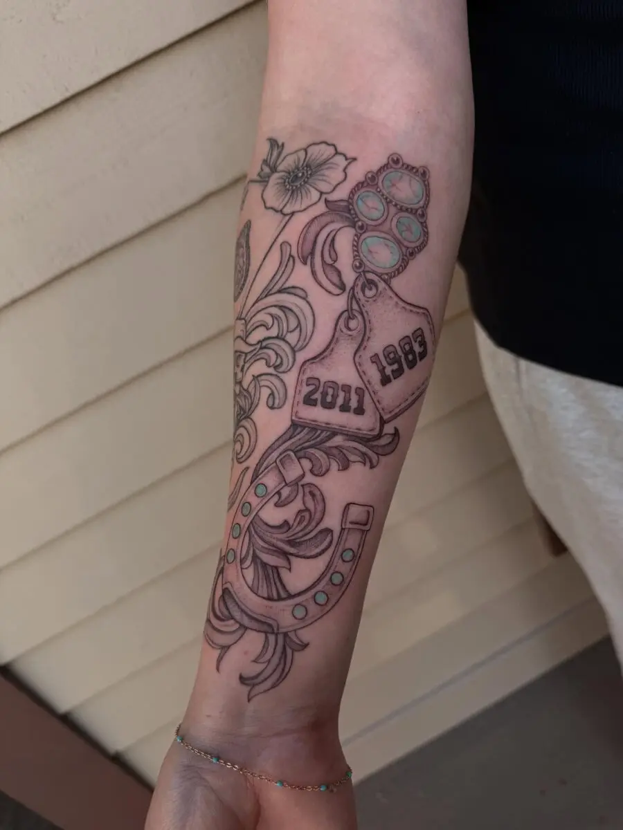 Elegant horseshoe tattoo with floral accents