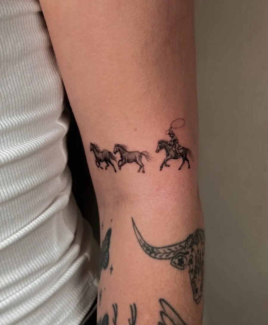 Dynamic depiction of horses and rider tattoo