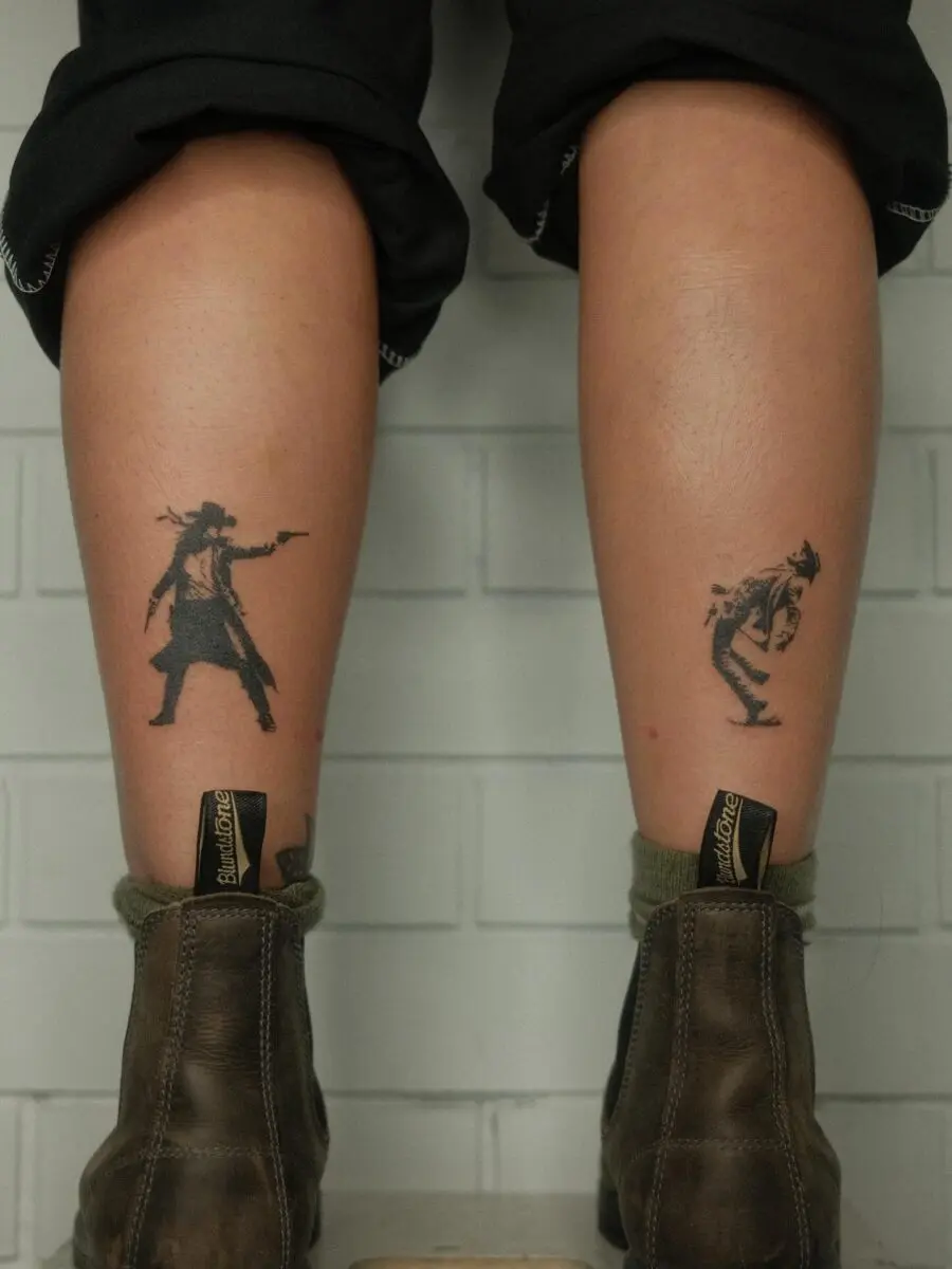 Dynamic cowboy tattoos showcasing strong western vibes.