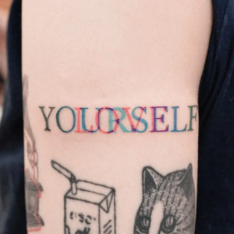 Colorful tattoo emphasizing self-love and identity