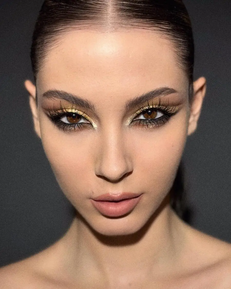 Striking baddie makeup with bold golden accents